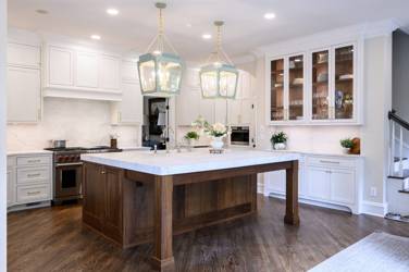 Two-tone kitchen with walnut island and white cabinetry in Cary, NC