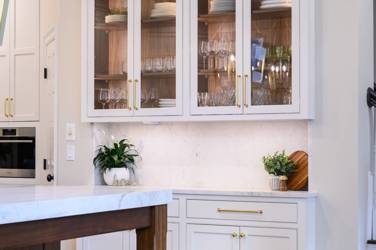Two-tone kitchen with walnut island and white cabinetry in Cary, NC