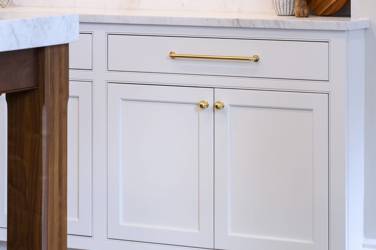 Two-tone kitchen with walnut island and white cabinetry in Cary, NC