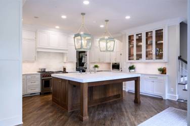Two-tone kitchen with walnut island and white cabinetry in Cary, NC