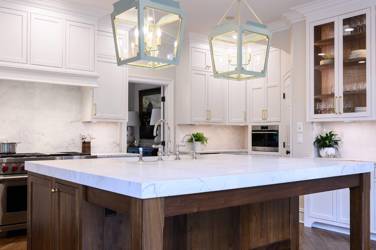 Two-tone kitchen with walnut island and white cabinetry in Cary, NC