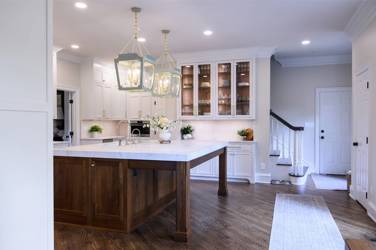 Two-tone kitchen with walnut island and white cabinetry in Cary, NC