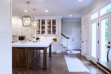 Two-tone kitchen with walnut island and white cabinetry in Cary, NC