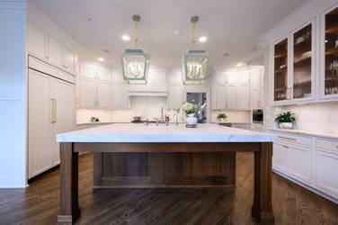 Two-tone kitchen with walnut island and white cabinetry in Cary, NC