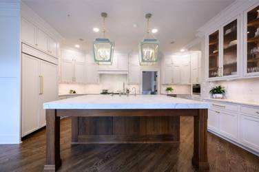 Two-tone kitchen with walnut island and white cabinetry in Cary, NC
