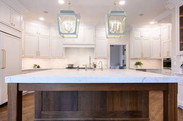 Two-tone kitchen with walnut island and white cabinetry in Cary, NC