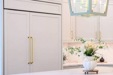 Two-tone kitchen with walnut island and white cabinetry in Cary, NC