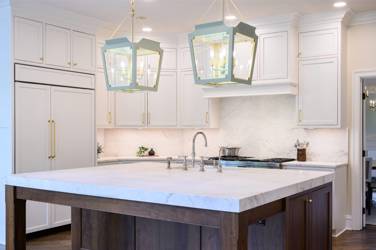Two-tone kitchen with walnut island and white cabinetry in Cary, NC