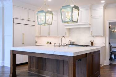 Two-tone kitchen with walnut island and white cabinetry in Cary, NC