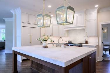 Two-tone kitchen with walnut island and white cabinetry in Cary, NC