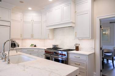 Two-tone kitchen with walnut island and white cabinetry in Cary, NC