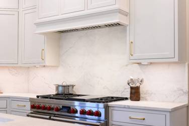Two-tone kitchen with walnut island and white cabinetry in Cary, NC