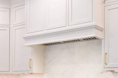 Two-tone kitchen with walnut island and white cabinetry in Cary, NC