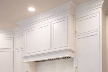 Two-tone kitchen with walnut island and white cabinetry in Cary, NC