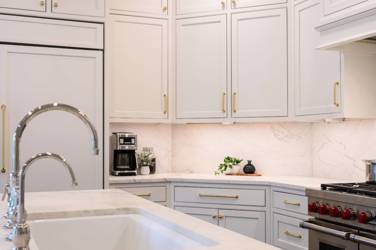 Two-tone kitchen with walnut island and white cabinetry in Cary, NC