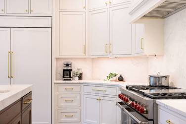 Two-tone kitchen with walnut island and white cabinetry in Cary, NC