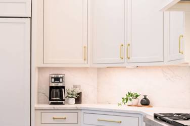 Two-tone kitchen with walnut island and white cabinetry in Cary, NC