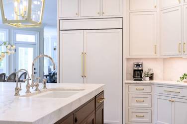 Two-tone kitchen with walnut island and white cabinetry in Cary, NC