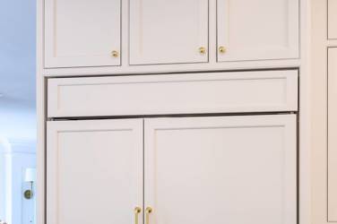 Two-tone kitchen with walnut island and white cabinetry in Cary, NC
