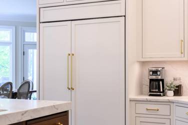 Two-tone kitchen with walnut island and white cabinetry in Cary, NC
