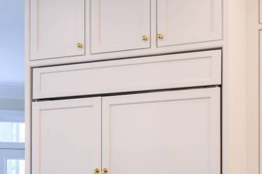 Two-tone kitchen with walnut island and white cabinetry in Cary, NC
