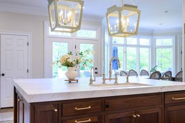 Two-tone kitchen with walnut island and white cabinetry in Cary, NC