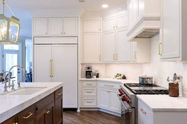 Two-tone kitchen with walnut island and white cabinetry in Cary, NC