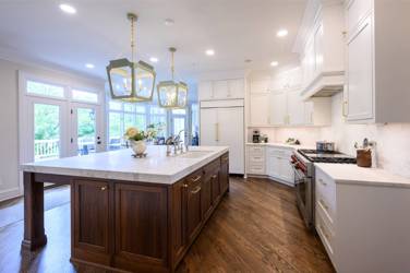 Two-tone kitchen with walnut island and white cabinetry in Cary, NC