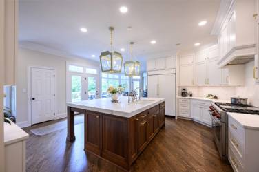 Two-tone kitchen with walnut island and white cabinetry in Cary, NC