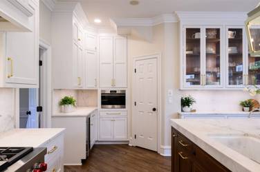Two-tone kitchen with walnut island and white cabinetry in Cary, NC