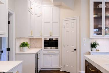 Two-tone kitchen with walnut island and white cabinetry in Cary, NC