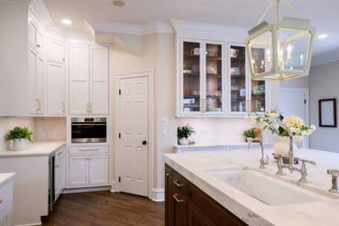 Two-tone kitchen with walnut island and white cabinetry in Cary, NC
