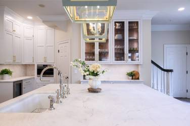 Two-tone kitchen with walnut island and white cabinetry in Cary, NC
