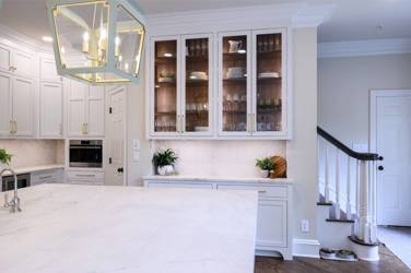 Two-tone kitchen with walnut island and white cabinetry in Cary, NC
