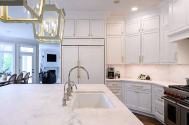 Two-tone kitchen with walnut island and white cabinetry in Cary, NC