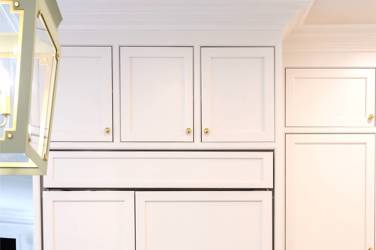 Two-tone kitchen with walnut island and white cabinetry in Cary, NC