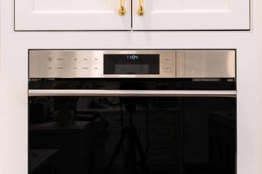 Two-tone kitchen with walnut island and white cabinetry in Cary, NC