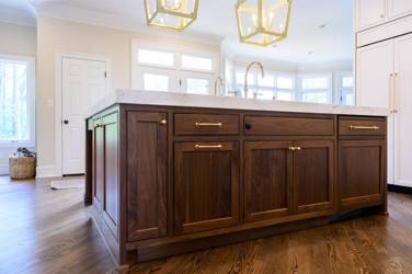Two-tone kitchen with walnut island and white cabinetry in Cary, NC