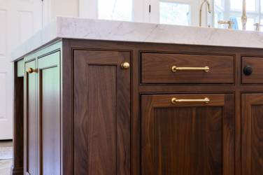 Two-tone kitchen with walnut island and white cabinetry in Cary, NC