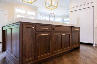 Two-tone kitchen with walnut island and white cabinetry in Cary, NC
