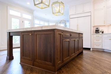Two-tone kitchen with walnut island and white cabinetry in Cary, NC