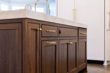 Two-tone kitchen with walnut island and white cabinetry in Cary, NC