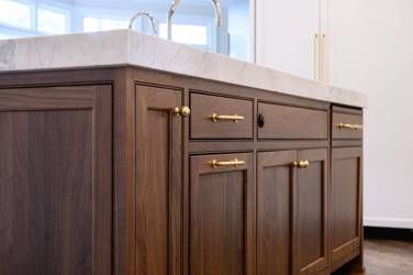 Two-tone kitchen with walnut island and white cabinetry in Cary, NC