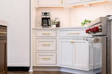 Two-tone kitchen with walnut island and white cabinetry in Cary, NC