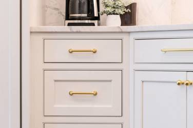 Two-tone kitchen with walnut island and white cabinetry in Cary, NC