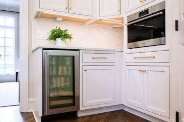 Two-tone kitchen with walnut island and white cabinetry in Cary, NC
