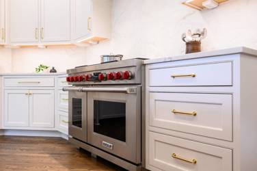 Two-tone kitchen with walnut island and white cabinetry in Cary, NC