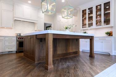 Two-tone kitchen with walnut island and white cabinetry in Cary, NC