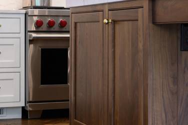 Two-tone kitchen with walnut island and white cabinetry in Cary, NC