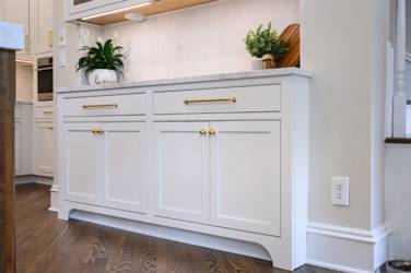 Two-tone kitchen with walnut island and white cabinetry in Cary, NC